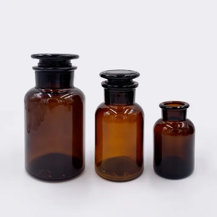Amber pharmacy glass jars with cork stoppers in multiple sizes