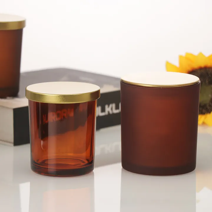 Amber candle jars with gold lids in a home setting