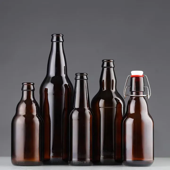 Amber beer bottles in assorted heights and shapes