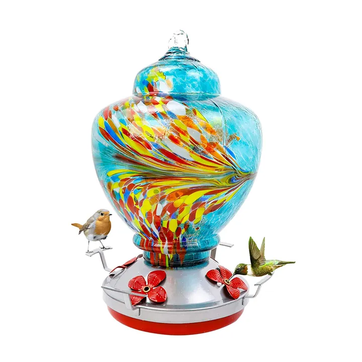 Blue round glass bird feeder with decorative base