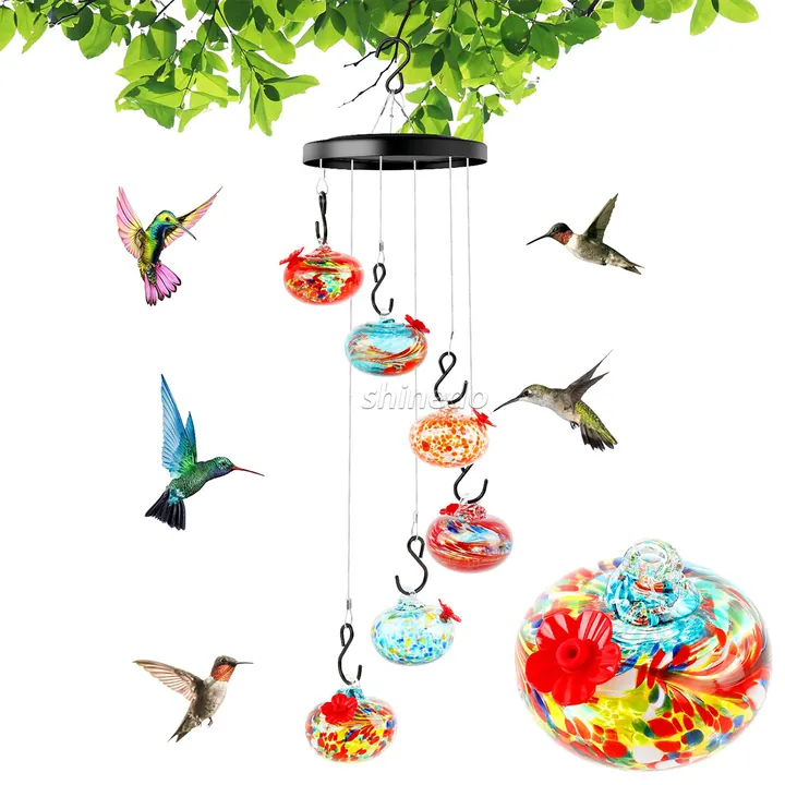 Colorful glass bird feeders hanging in wind chime style outdoor setup