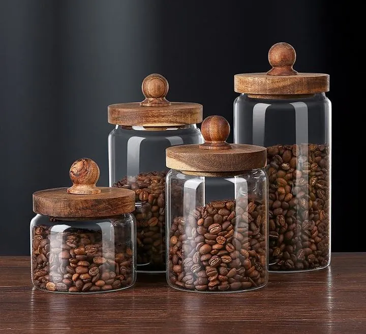 Glass storage jars with acacia wood lids and coffee beans