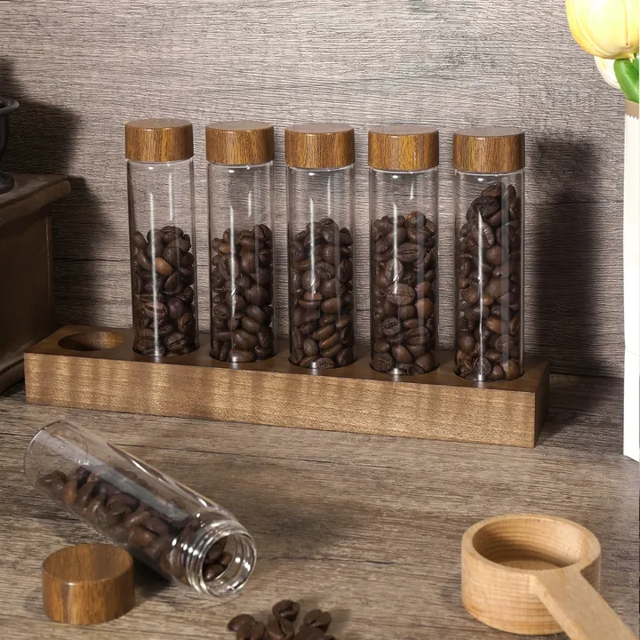 Glass coffee bean containers displayed on wooden rack