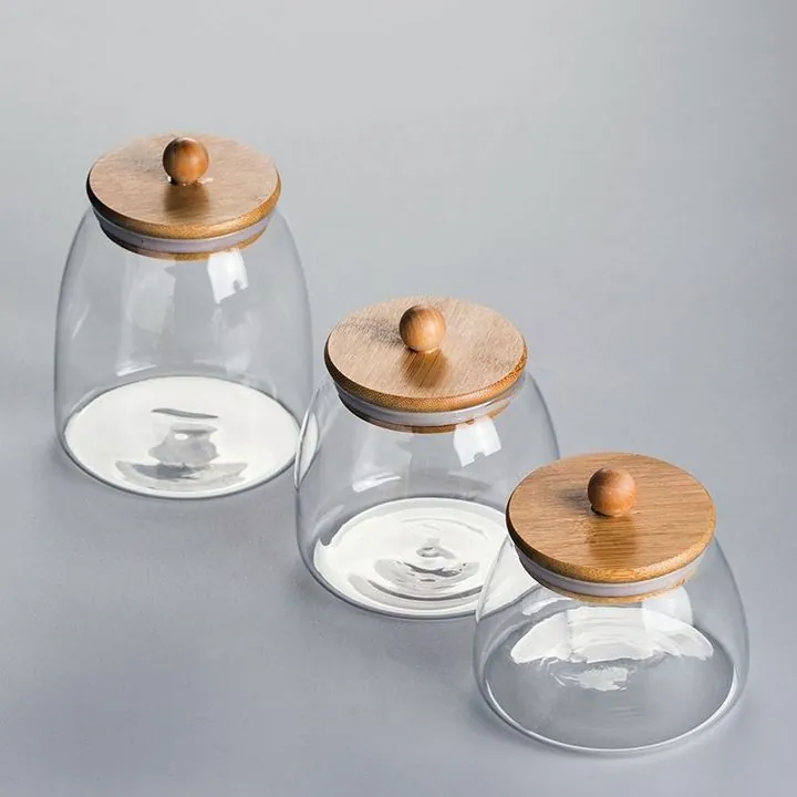 Round glass storage jars with wooden lids