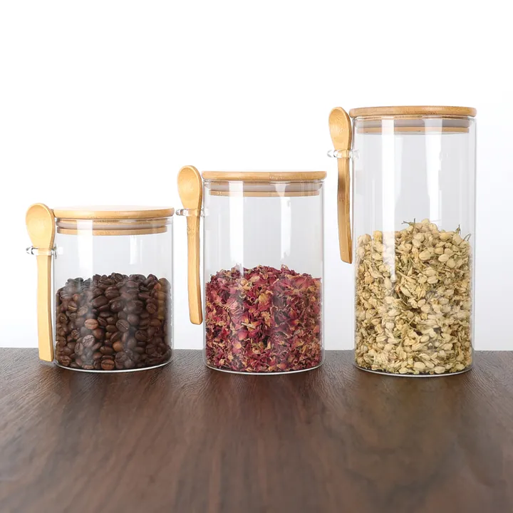 Glass storage jars with bamboo lids and attached wooden spoons