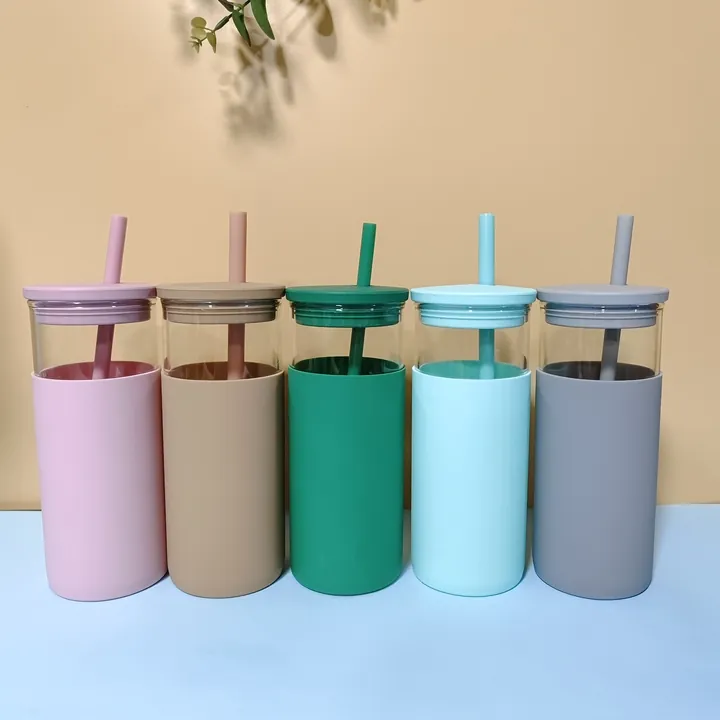 Five glass cups with different colored silicone sleeves lids and straws