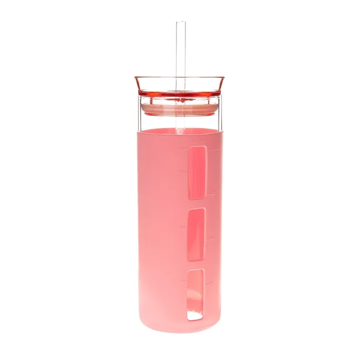 Glass cup with pink silicone sleeve and straw
