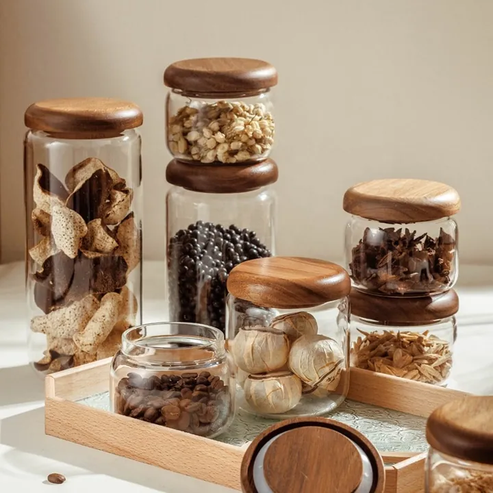 Glass storage jars with dark wooden lids and spices