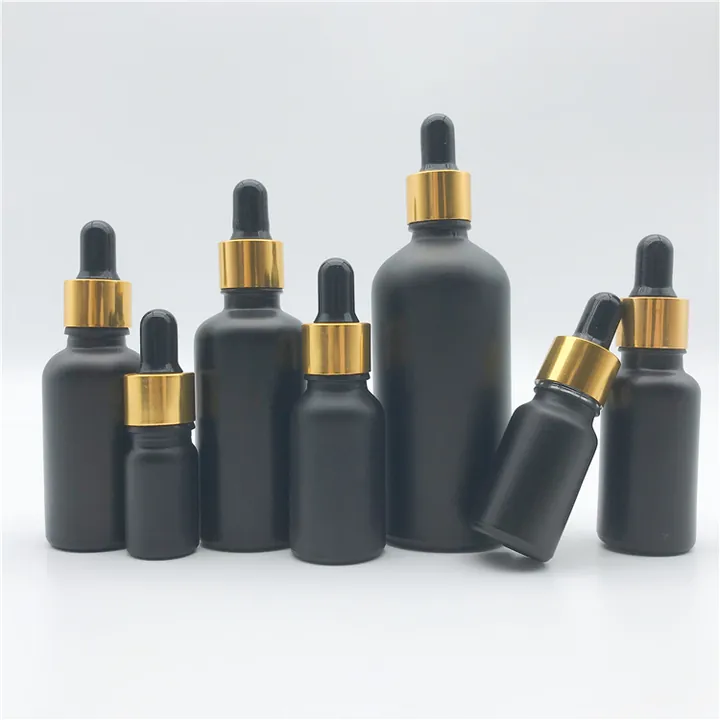 Amber Boston round bottles with gold closures and dispensing accessories
