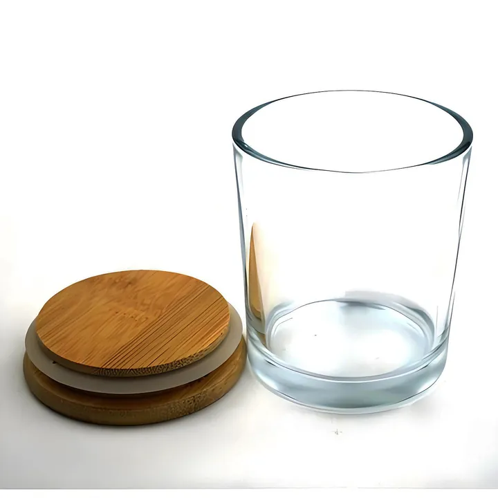 Ein Kerzenglas aus klarem Glas mit einem Bambusdeckel daneben