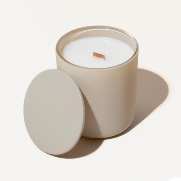 Matte beige glass candle jar with round lid and white wax