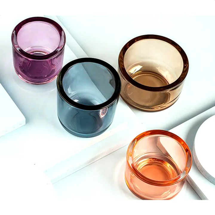 Colored transparent candle jars in purple blue brown and orange