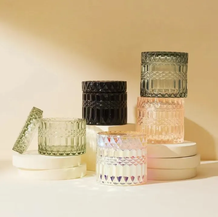 Embossed glass candle jars in clear black green and pink colors