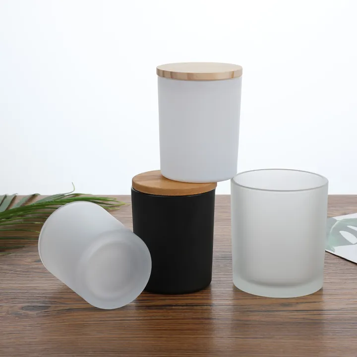 Black white and frosted glass candle jars with wooden lids