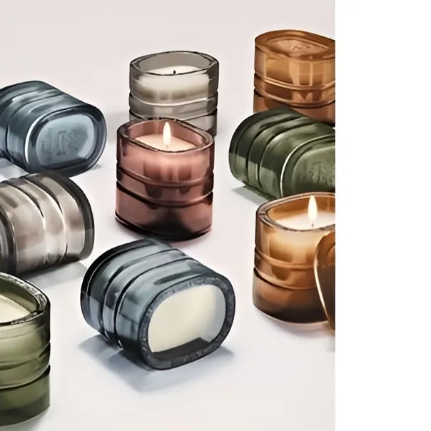 Colorful square glass candle jars with some candles lit