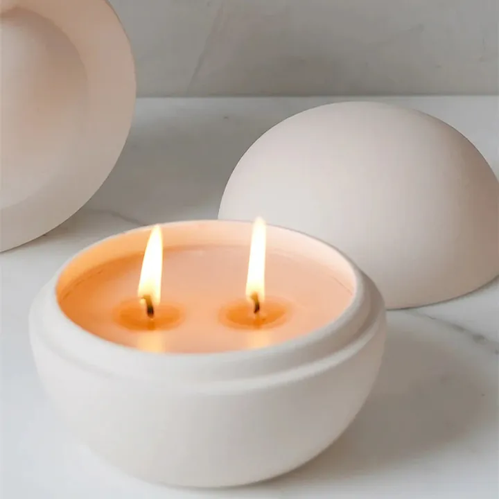 White round bowl shaped candle jar with two burning wicks