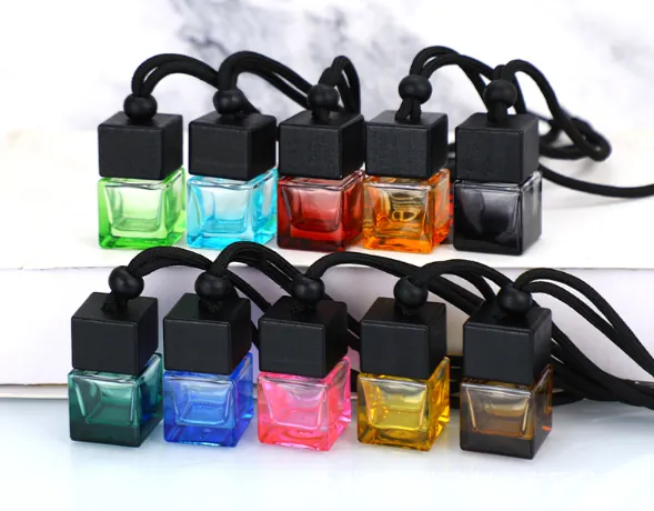 Multiple colorful square car diffuser bottles with black caps and hanging cords