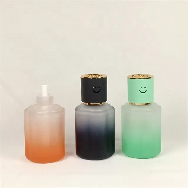 Three frosted gradient car diffuser bottles in orange black and green