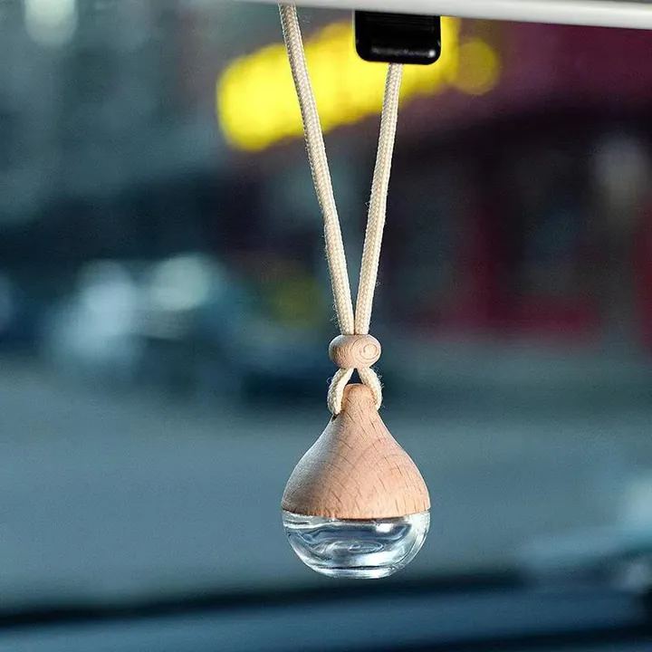 Drop shaped car diffuser bottle with wooden pointed cap and hanging cord