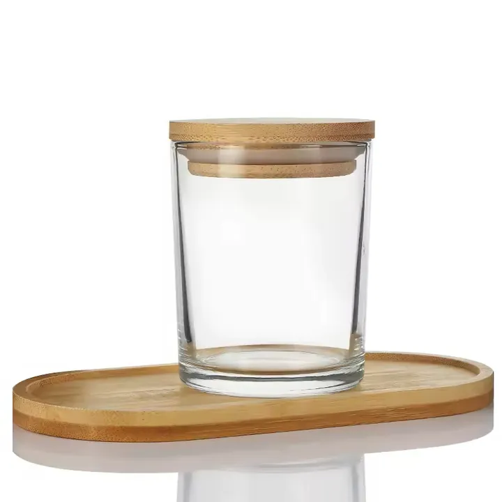 Clear glass candle jar with bamboo lid displayed on a bamboo tray
