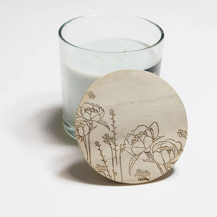 Clear glass candle jar with carved floral wooden lid