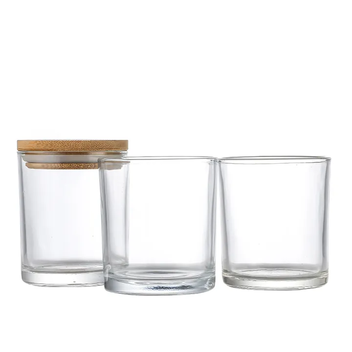 Three clear cylindrical glass candle jars in different sizes