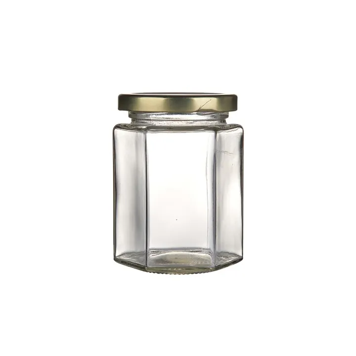 Clear hexagon honey jar with gold metal screw lid