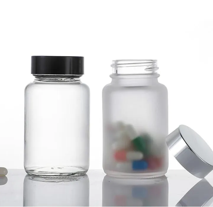 Clear and frosted pharmacy jars with capsules inside