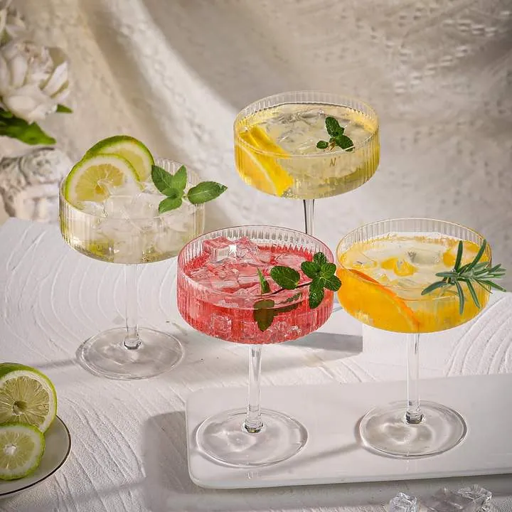 Four ribbed coupe glasses displayed together