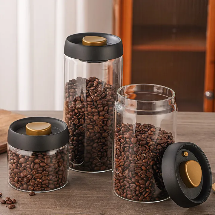Round glass coffee jars with airtight lids displayed in a kitchen setting