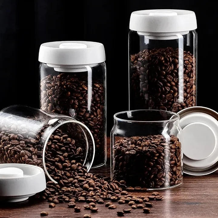 Glass coffee jars with white lids and coffee beans displayed