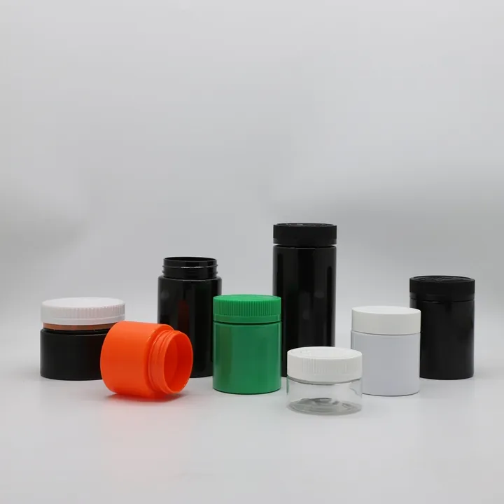 Colored medicine jars in black white green and orange