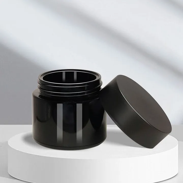 Black cream jar with open cap and wide-mouth body