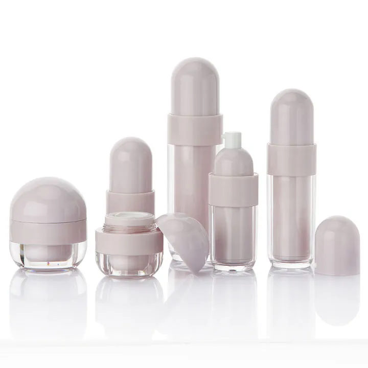 Pink refillable cosmetic bottle set with dropper and round cap bottles