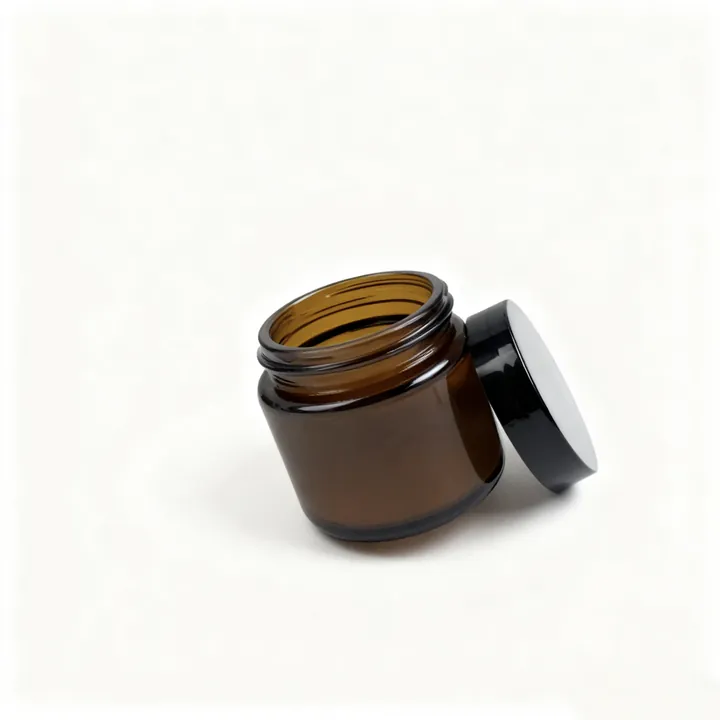 Amber cosmetic glass jar with black lid