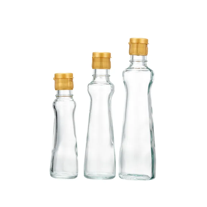 Drei durchsichtige, gewölbte Glasflaschen mit goldenen Klappverschlüssen