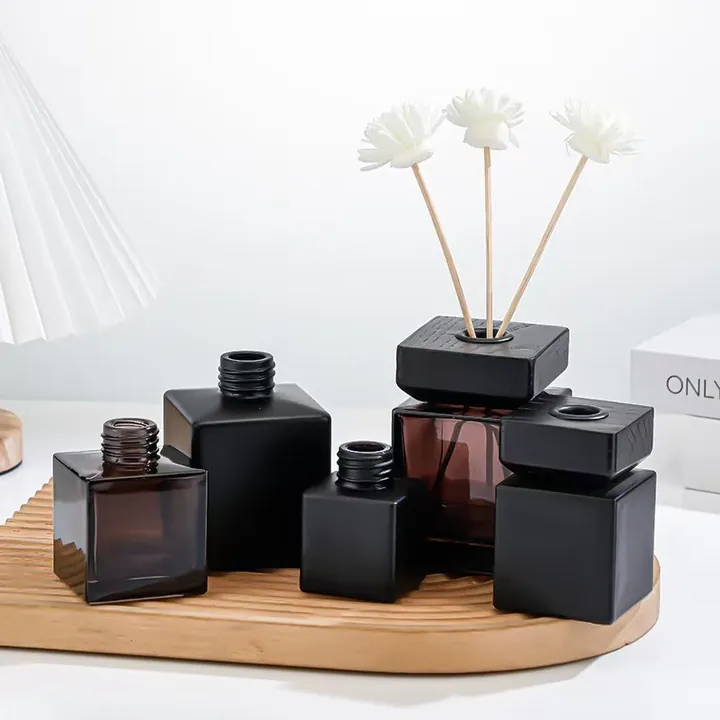 Black and brown square diffuser bottles with white fragrance flowers