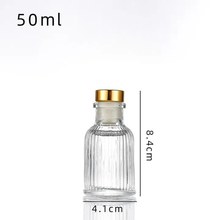 Clear ribbed diffuser bottle with gold cap and capacity size information