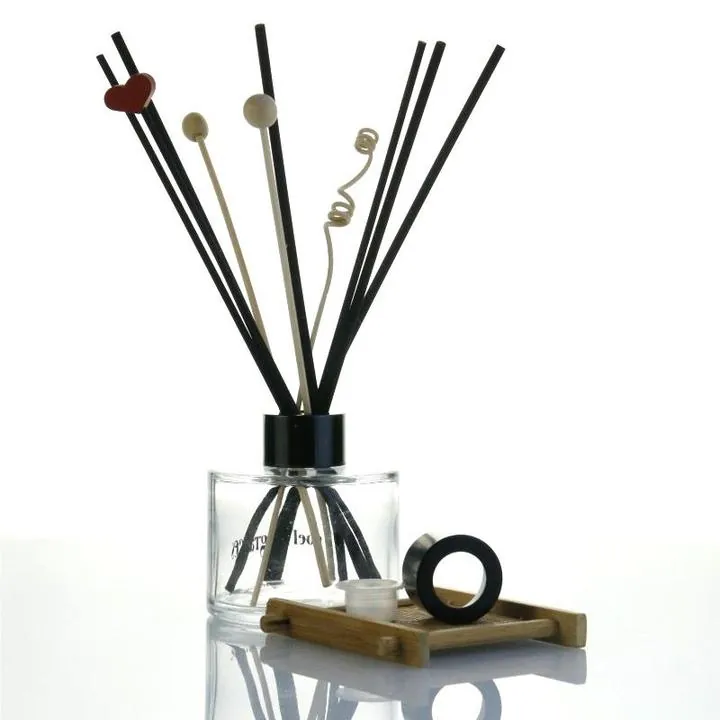 Clear round diffuser bottle with black reeds decorative sticks wood tray and cap