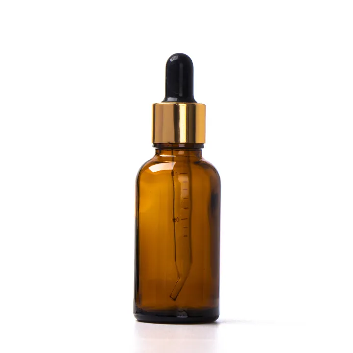 Amber glass dropper bottle with gold cap and black bulb