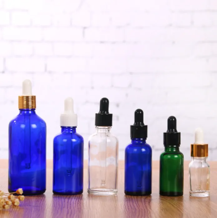 Glass dropper bottles in multiple colors and capacities displayed together