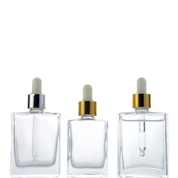 Clear square glass dropper bottles with gold and silver caps