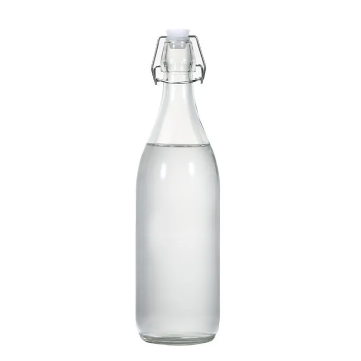 Botella de cristal transparente con tapón abatible, llena de un líquido transparente