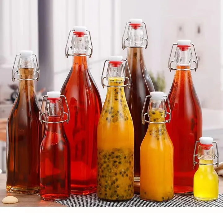 Swing top glass bottles filled with red yellow and dark beverages