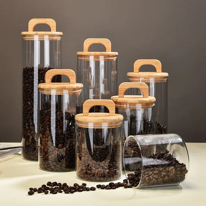 Glass food storage jars with handle bamboo lids filled with coffee beans