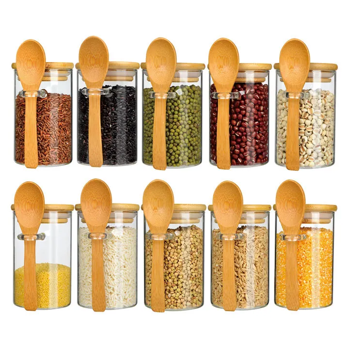 Glass food storage jars with bamboo lids and wooden spoons
