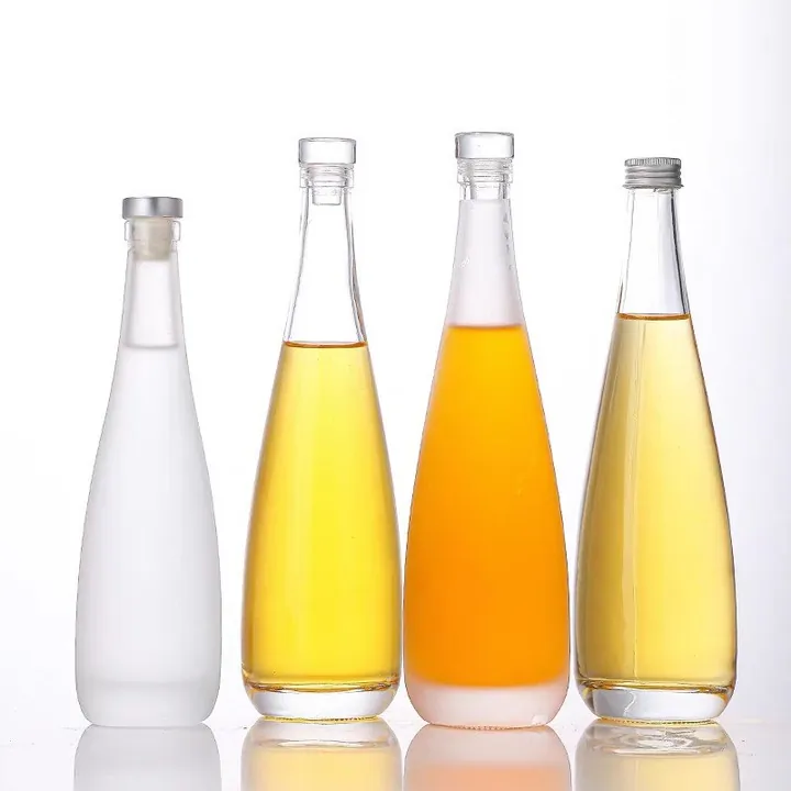 Cuatro botellas de bebida de cuello estrecho y acabado esmerilado con tapones diferentes