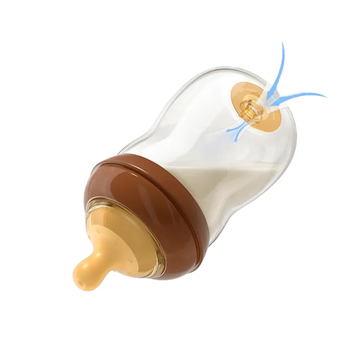 Glass baby bottle with brown cap and nipple displayed at an angle