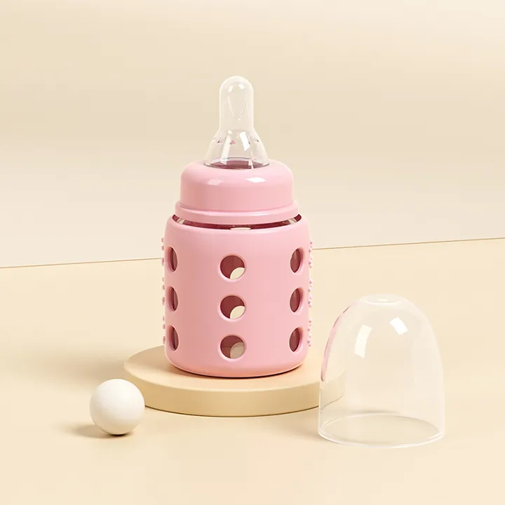 Glass baby bottle with pink silicone sleeve nipple and clear dust cap