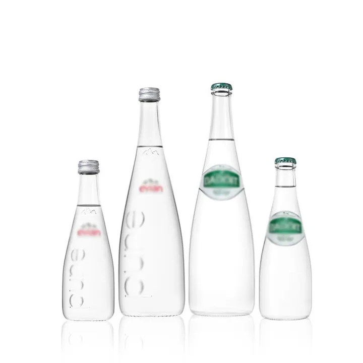 Clear beverage bottles with branded labels and embossed details